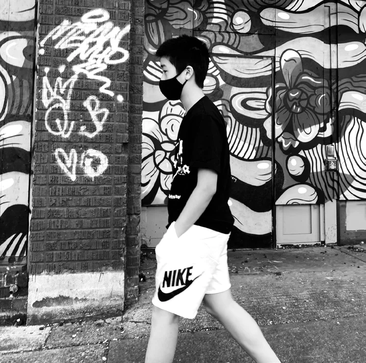 Tony D walking past a painted wall